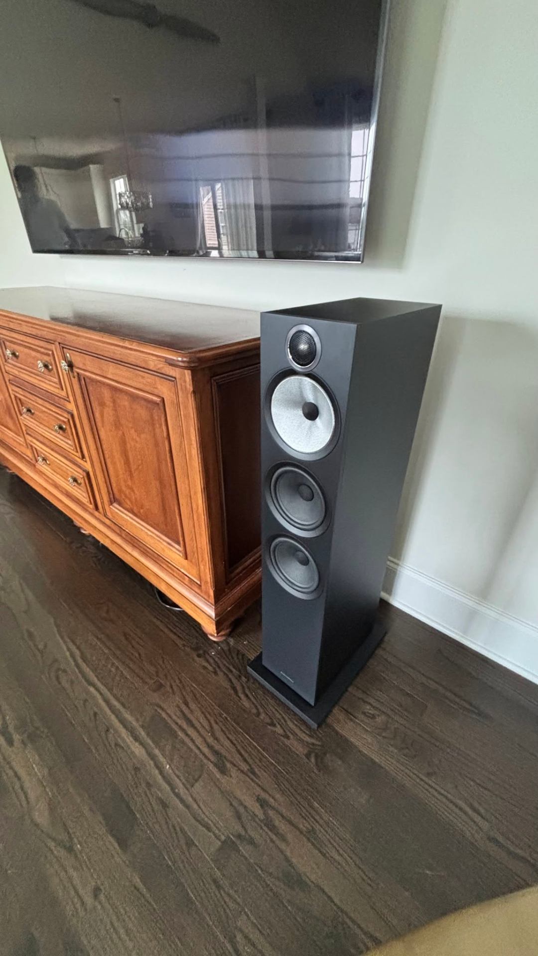 Bowers & Wilkins tower speaker paired with wall-mounted display
