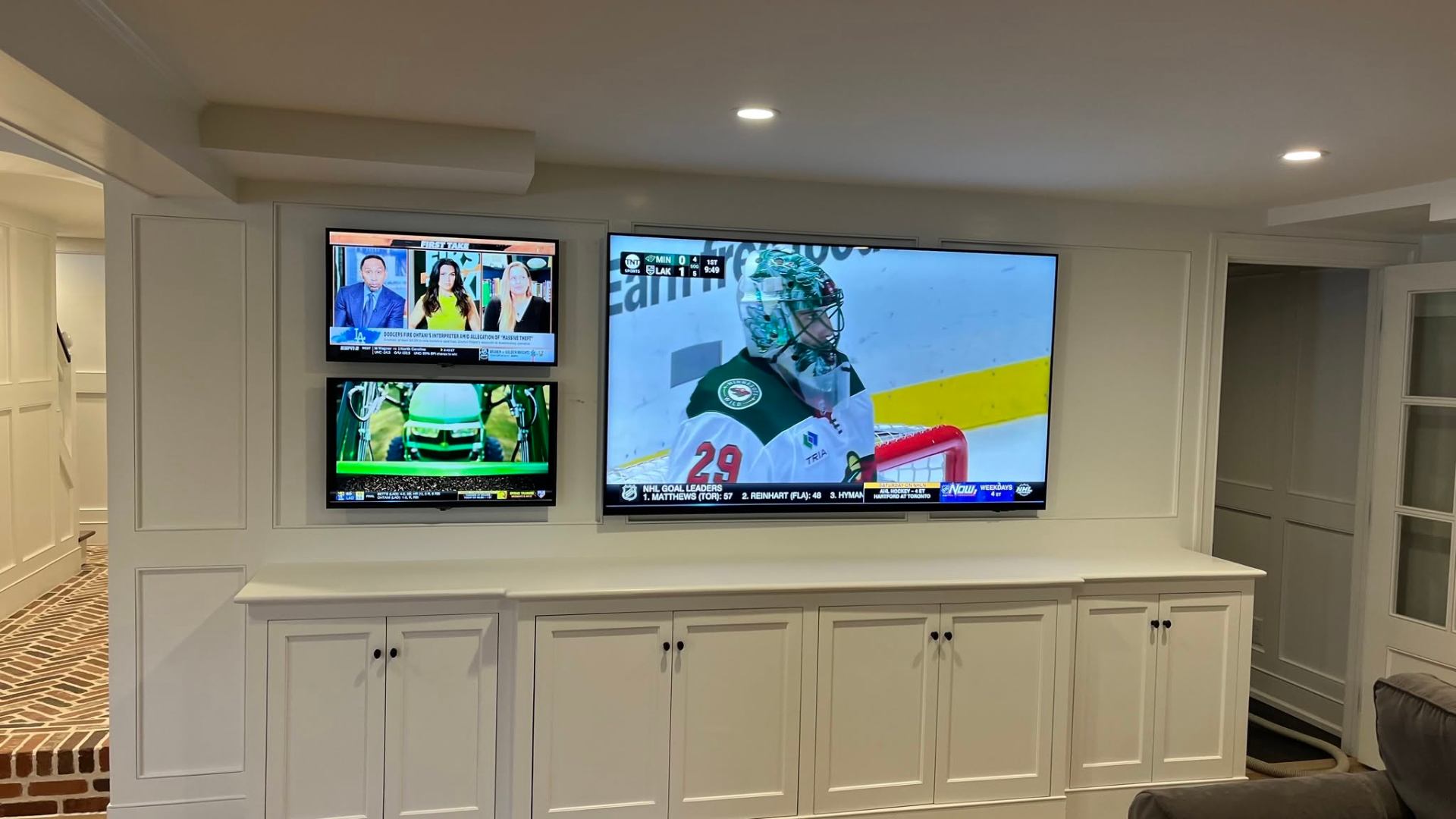 Three-TV sports lounge with millwork integration